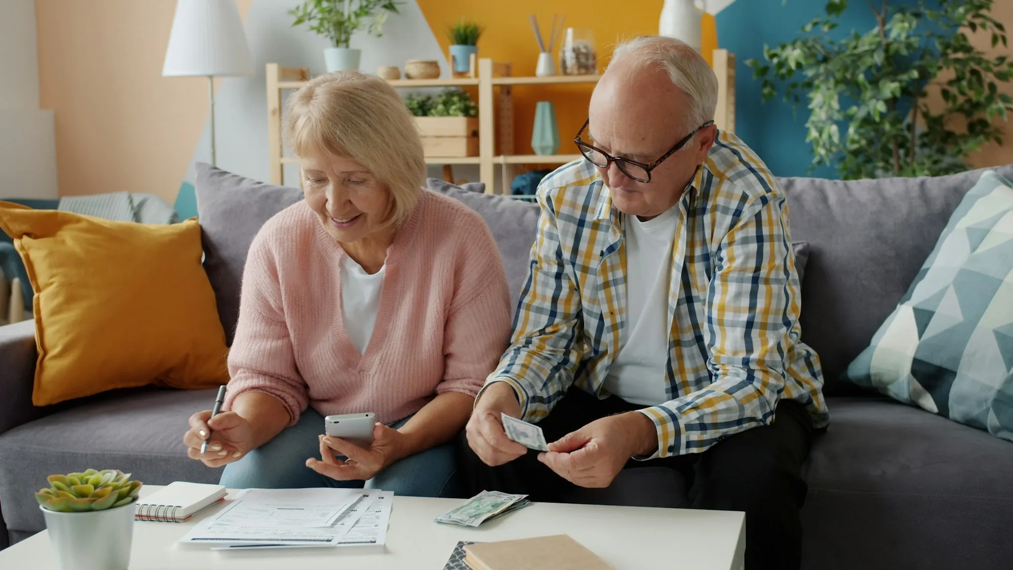 Two people going through paperwork together at a dining table